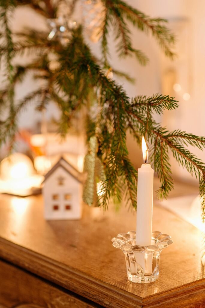 A Close-Up Shot of a Lighted Candle on a Wooden Surface