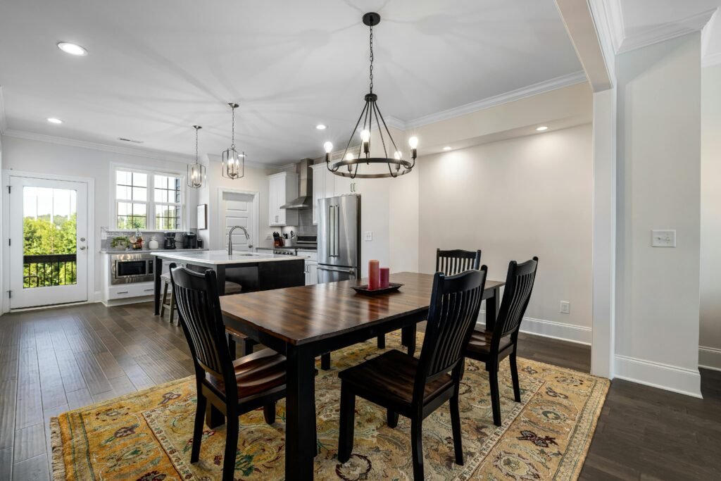 Elegant dining space with wooden floor and chandeliers in a modern interior.